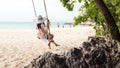 Summer Vacations. Lifestyle women relaxing and enjoying swing on the sand beach, Royalty Free Stock Photo