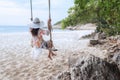 Summer Vacations. Lifestyle women relaxing and enjoying swing on the sand beach, Royalty Free Stock Photo