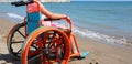 Summer Vacations of a little girl on the wheelchair on the beach