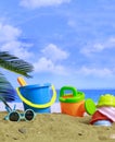 Summer vacations. Plastic toys for kids activities on a sandy beach. Blur sea background Royalty Free Stock Photo