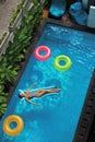 Summer Vacations. Woman Sunbathing, Floating In Swimming Pool Water Royalty Free Stock Photo