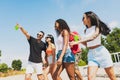 Group of young people, men and women resting on the beach, drinking cool drinks, having fun sunbathing Royalty Free Stock Photo