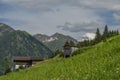 Summer valley with Grossarler Ache small river and blue cloudy sky