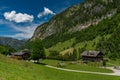 Summer valley with Grossarler Ache small river and blue cloudy sky