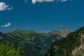 Summer valley with Grossarler Ache small river and blue cloudy sky