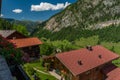 Summer valley with Grossarler Ache small river and blue cloudy sky