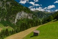 Summer valley with Grossarler Ache small river and blue cloudy sky