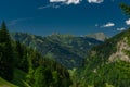 Summer valley with Grossarler Ache small river and blue cloudy sky