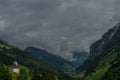 Summer valley with Grossarler Ache small river and blue cloudy sky and church