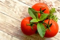 Summer vegetarian food, three tomatoes with aromatic herbs Royalty Free Stock Photo