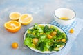 Summer Vegitarian salad of corn, avocado and yellow cherry tomatoes with lettuce and basil. Citrus sauce on a blue background Royalty Free Stock Photo