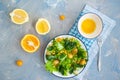 Summer Vegitarian salad of corn, avocado and yellow cherry tomatoes with lettuce and basil. Citrus sauce on a blue background Royalty Free Stock Photo