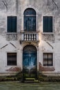 Facade of old house with vintage blue door and windows, on a canal in Venice, Italy Royalty Free Stock Photo