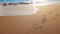 Summer Vibe Beach Waves with Footprints Royalty Free Stock Photo