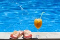 Summer vibes with cocktail, pool and shoes Royalty Free Stock Photo