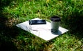 Summer vibes. Relax. laptop with headset of mobile phone and coffee to go on green grass. agile business. Online study Royalty Free Stock Photo