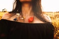 Summer vibes spirit in a wild field. Girl neck and open shoulders close-up with blooming flowers put in dress