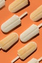 Varying popsicles on an orange background. Flat lay of ice creams in pop-art style