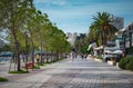 Summer view of alley with palms in Saranda Albania, Promenade walkway by the beach with date palms and restaurants Royalty Free Stock Photo