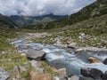 Summer view of alpine landscape with snow-capped mountain peaks and wild Freigerbach stream. Tyrol, Stubai Alps, Austria Royalty Free Stock Photo