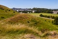 Summer view of Salisbory Crags in Holyrood Park near Arthur`s Seat with beautiful green grass and blue sky in Edinburgh, Scotland Royalty Free Stock Photo