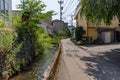 Summer view of small back street with watercourse, downtown Kanazawa, Ishikawa Prefecture, Japan