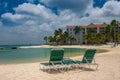 ORANJESTAD, ARUBA - October 12.2007: View on the sun beds on the sandy beach and turquoise sea in the hotel resort. Royalty Free Stock Photo