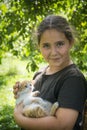 In the summer in the village, a girl holds a white-red little kitten in her arms Royalty Free Stock Photo