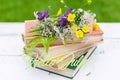 Summer vintage composition. Old books, a bouquet of wild flowers on a rustic background. Caption: Hello July Royalty Free Stock Photo