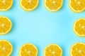 Summer and vitamins background frame. Lemon on a blue background, minimal food concept