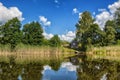 Summer water landscape with a moorage and a house