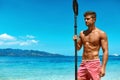 Summer Water Sport. Man With Canoe Kayak Paddle On Beach