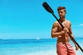 Summer Water Sport. Man With Canoe Kayak Paddle On Beach