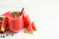 Summer watermelon drink in glass, sliced fresh fruit and space for text