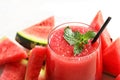 Summer watermelon drink in glass and sliced fresh fruit on table Royalty Free Stock Photo