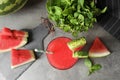 Summer watermelon drink in glass, sliced fruit and mint on table Royalty Free Stock Photo