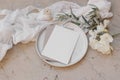 Summer wedding stationery. Birthday mock-up scene. Blank greeting cards on plate. White oleander blossom, ribbon and