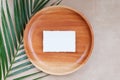 Summer wedding stationery mock-up scene. Blank business card, invitation in sunlight. Wooden plate, palm leaves, greeting card. Co