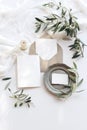 Summer wedding stationery mock-up scene. Blank greeting cards, envelope, vintage silver plate, olive branches and ribbon