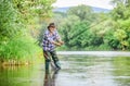 Summer weekend. Big game fishing. man fly fishing. man catching fish. hobby and sport activity. pothunter. retired Royalty Free Stock Photo