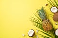 Summer weekend concept. Top view photo of fresh tropical fruits coconuts pineapple and palm leaves on isolated yellow background Royalty Free Stock Photo