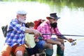 Summer weekend. Fly fisherman using fly fishing rod in river. Little boy fly fishing on a lake with his father and Royalty Free Stock Photo