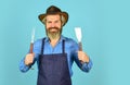 Summer weekend. happy hipster hold cooking utensils for barbecue. bearded man chef. Tools for roasting meat outdoors Royalty Free Stock Photo