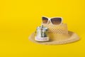 Summer weekend travel vacation concept. Beach accessories, straw hat, white sunglasses and save money glass jar with dollars Royalty Free Stock Photo