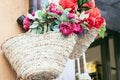 Summer wicker bags made of straw and rattan with textile flowers on the market in Taormina, Sicily, Italy