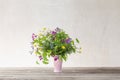 The summer wild flowers in pink ceramic  vase on white background Royalty Free Stock Photo