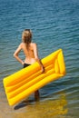 Summer woman hold yellow floating mat Royalty Free Stock Photo