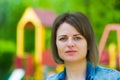 Summer woman portrait. Girl on a background of blurry children`s slides