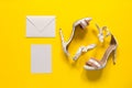 Summer women`s high-heeled shoes. Pink flamingos and feathers. Envelope and postcard. Yellow paper background