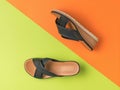 Summer women`s high-soled sandals on an orange-green background. Minimal concept of summer women`s shoes Royalty Free Stock Photo